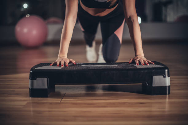 fit woman exercising alone in gym - single step imagens e fotografias de stock