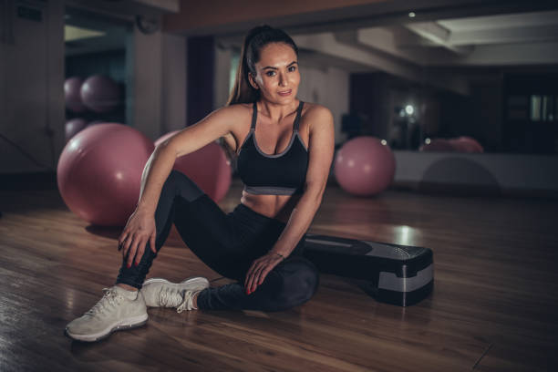 istock Lady sitting on the floor in gym 1135065188
