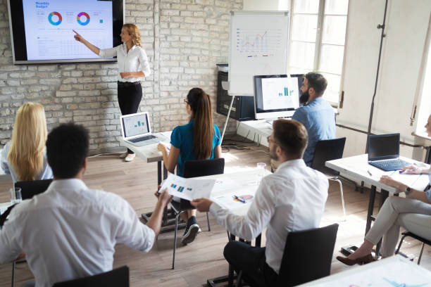 istock Successful happy group of people learning software engineering and business during presentation 1135065768