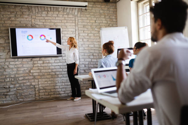 istock Successful happy group of people learning software engineering and business during presentation 1135065913