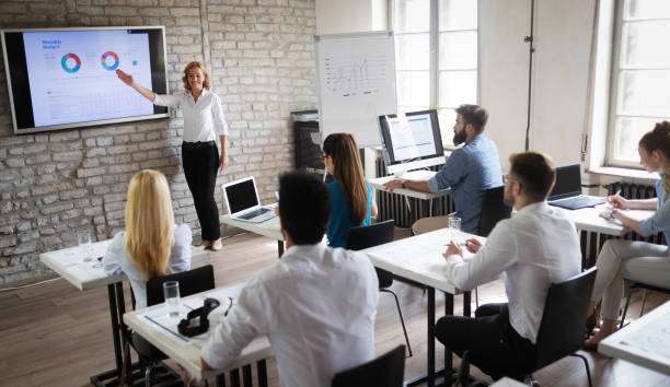 istock Successful happy group of people learning software engineering and business during presentation 1135065937