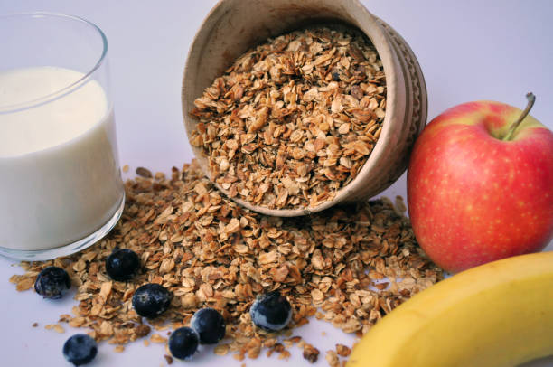 istock granola in a wooden container on a white background with milk and fruit 1135066587