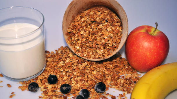 istock granola in a wooden container on a white background with milk and fruit 1135066620
