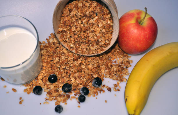 istock granola in a wooden container on a white background with milk and fruit 1135066626
