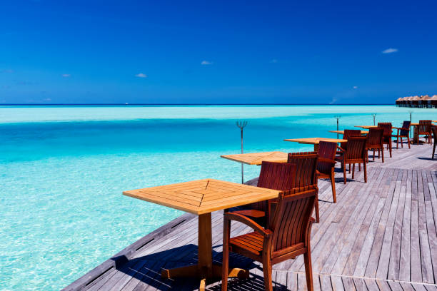 istock Tables and chairs at tropical beach restaurant 1135068097