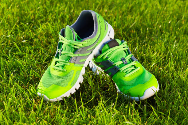 istock sneaker shoes on green grass field 1135068168