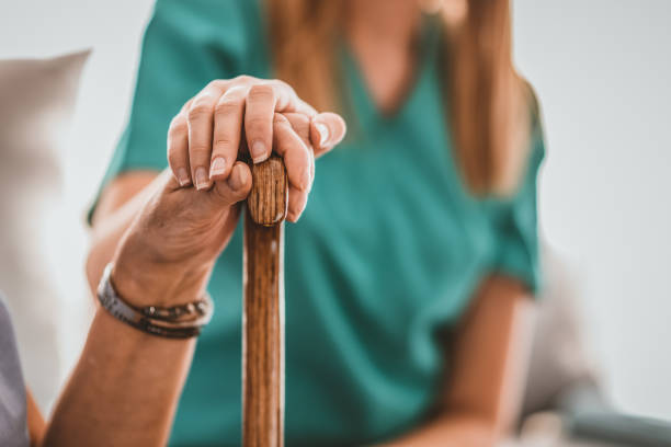 istock Nurse comforting elder lady 1135068173