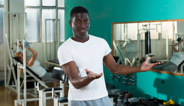 istock Friendly afro man welcoming to gym 1135070200