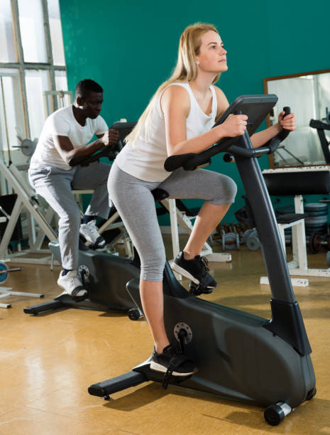 istock Couple training on stationary cycles 1135070209