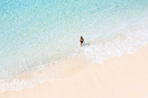 https://media.istockphoto.com/id/1135071521/photo/bali-young-woman-on-the-white-sand-beach-beside-the-transparent-turquoise-sea-aerial-drone.jpg?b=1&s=170667a&w=0&k=20&c=KgE3BrukNporWh9kXCb9aH-A6K1C_W2baG2wveg7L9c=