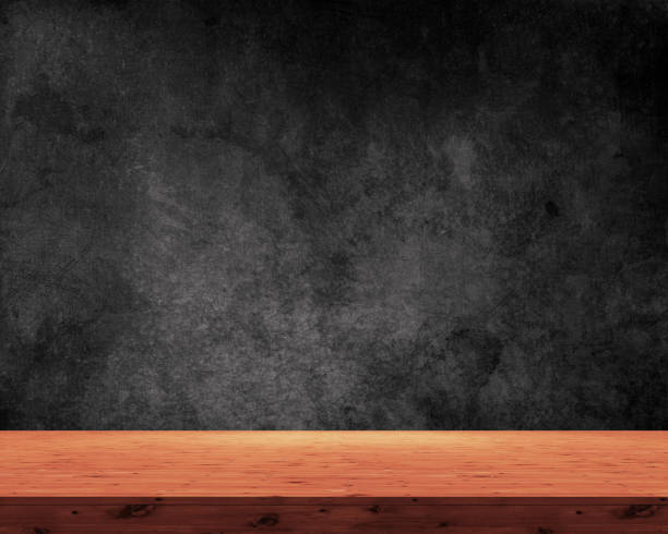 istock 3D wooden table on a grunge black background 1135071557