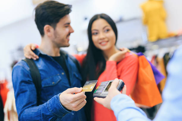 istock Couple Purchasing Clothing 1135071798