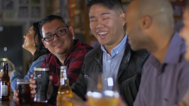 Men cheers toasting at sports bar