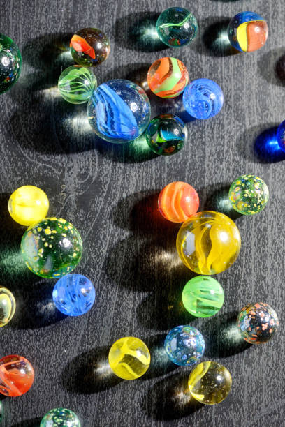 istock Glass marble balls and shadows on black table 1135072286