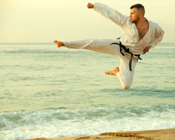 istock Laughing male practising karate kata poses 1135072307