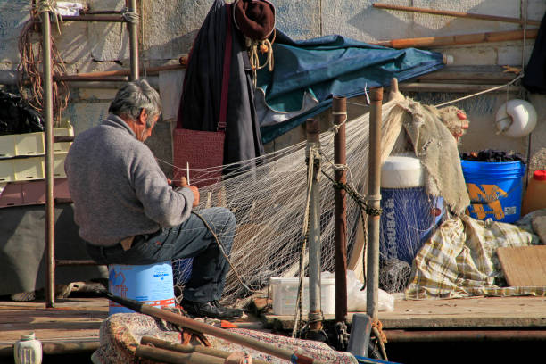 fisherman preparing his nets for a day of work on the sea.