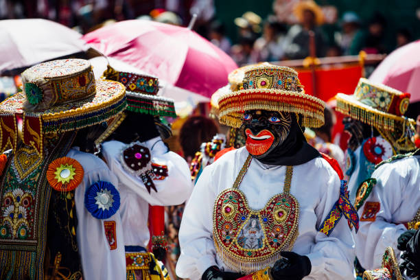 masked dancers on assumption day in Coya stock photo