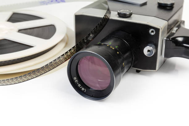 Vintage amateur movie camera and reels of Super 8-mm films Fragment of vintage amateur film movie camera and reels of color motion picture films Super 8-mm format close-up at selective focus on a white background vintage amateur movie camera stock pictures, royalty-free photos & images
