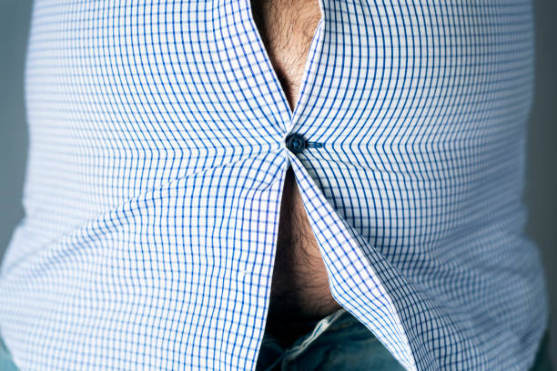 caucasian man with a pot belly closeup of a caucasian man, with a beer belly seen through the buttons of his shirt hairy fat man pictures stock pictures, royalty-free photos & images