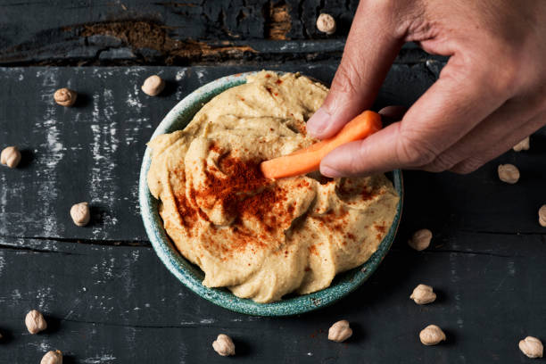 istock dipping carrot in a homemade hummus 1135074776