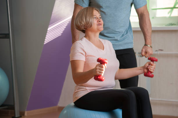 istock Pretty middle-aged woman trains with dumbbells 1135077258