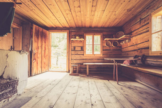 Mountain hut in Austria: rustic wooden interior Interior of an old rustic abandoned alpine chalet in Austria log cabin stock pictures, royalty-free photos & images