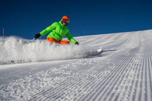 istock sunshine skiing skier stopping snow splashing 1135077457