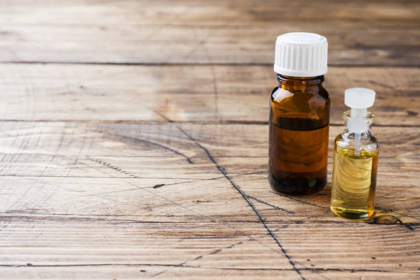 istock Jars of essential oils on a wooden background with copy space. 1135078972