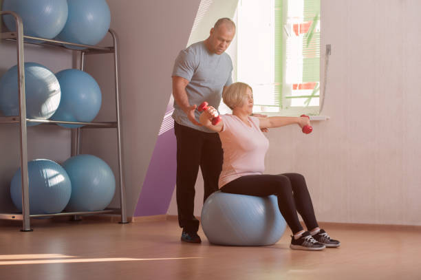 istock Pretty middle-aged woman trains with dumbbells 1135079193