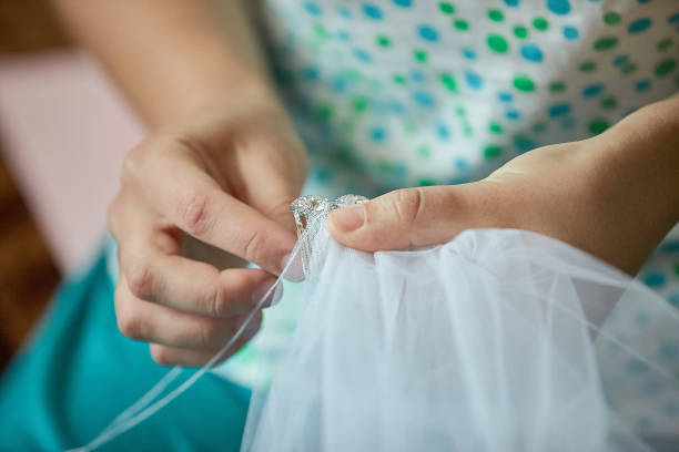 istock Tailor sewing the veil of a bride 1135079310