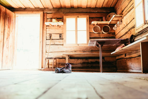 alpine boots on rustic wood floor in an abandoned mountain chalet in austria - home interior cabin shack european alps imagens e fotografias de stock