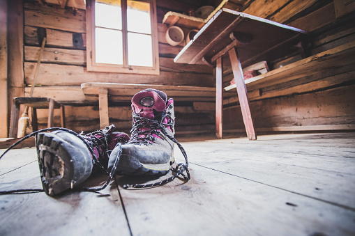 Alpine boots inside of a rustic mountain chalet, Austria