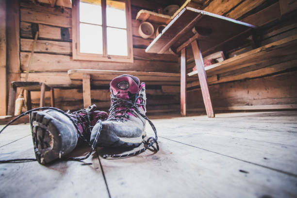alpine boots on rustic wood floor in an abandoned mountain chalet in austria - home interior cabin shack european alps imagens e fotografias de stock