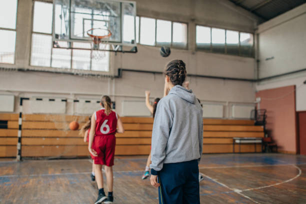 istock Woman basketball coach watching her players training 1135080385