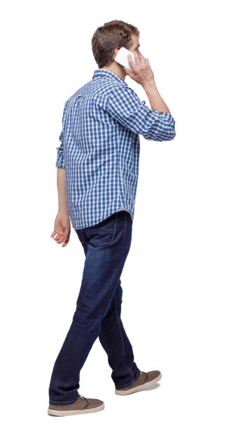 istock side view of man walking with a mobile phone. 1135080523