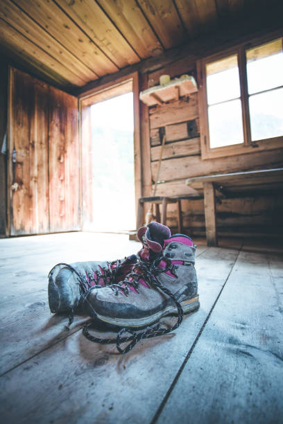 alpine boots on rustic wood floor in an abandoned mountain chalet in austria - home interior cabin shack european alps imagens e fotografias de stock