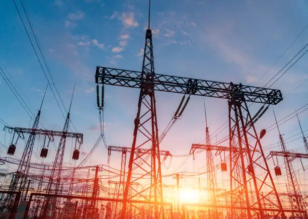 Photo of High-voltage power lines. Electricity distribution station. high voltage electric transmission tower. Distribution electric substation with power lines and transformers