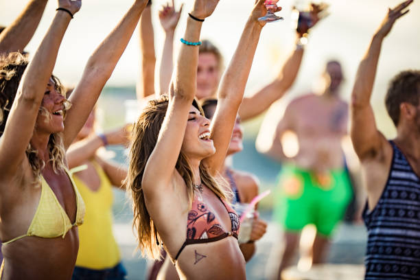 young happy people having fun with raised arms on a party in summer day. - image singing fun vacations imagens e fotografias de stock