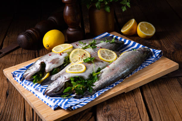 istock fresh trout with lemon and different herbs 1135083610