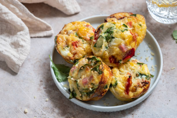 Egg muffins with ham, cheese and vegetables Delicious egg muffins with ham, cheese and vegetables frittata stock pictures, royalty-free photos & images