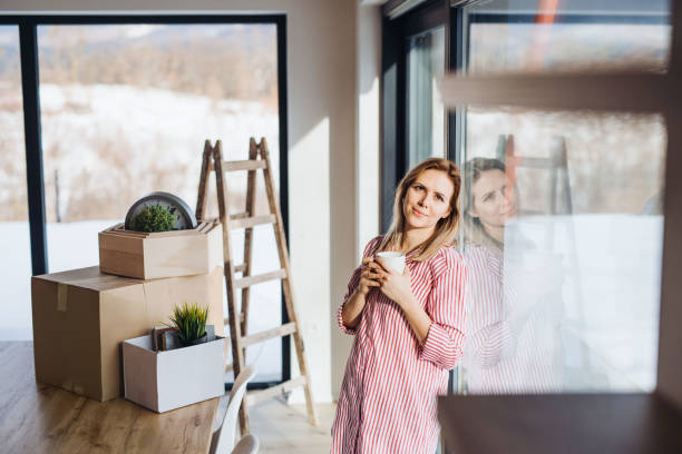 istock A young woman moving in new home, drinking coffee. 1135086302