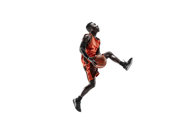 Full length portrait of a basketball player with ball Full length portrait of a basketball player with a ball isolated on white studio background. advertising concept. Fit african anerican athlete jumping with ball. Motion, activity, movement concepts. basketball player photos stock pictures, royalty-free photos & images