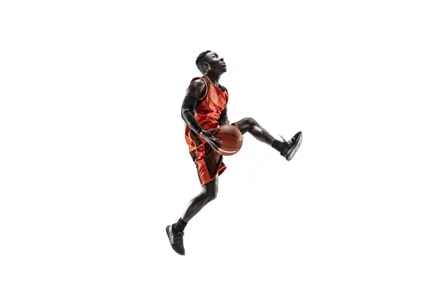 Photo of Full length portrait of a basketball player with ball
