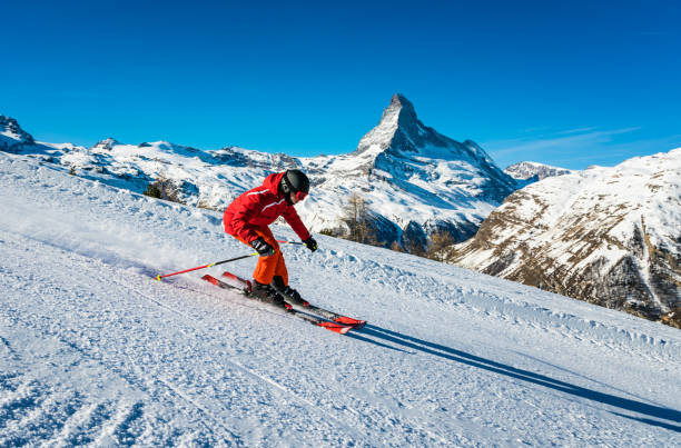 Young skier skiing at Zermatt ski resort, Switzerland Young skier skiing at Zermatt ski resort with Matterhorn mountain in background, Valais canton, Switzerland, in winter morning. Taken by Sony a7R II, 42 Mpix. pennine alps stock pictures, royalty-free photos & images