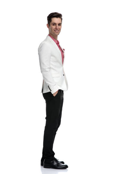 istock elegant man with hands in pockets looking at the camera 1135087871