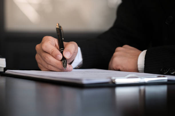 istock Businessman analyzing investment charts and pressing calculator buttons over documents. Accounting Concept. 1135087998
