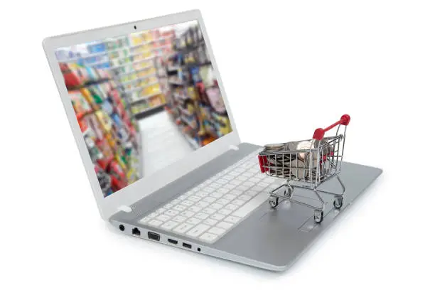 Photo of Internet online shopping concept with computer and cart