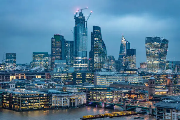 Photo of London city's financial district skyline during blue hour - stock image
