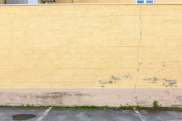 istock Old worn yellow concrete wall outdoors 1135090559