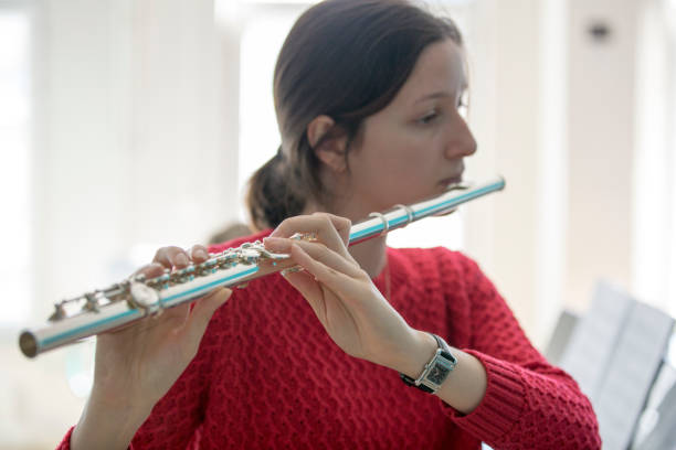 istock Young women playing piano and flute 1135091172